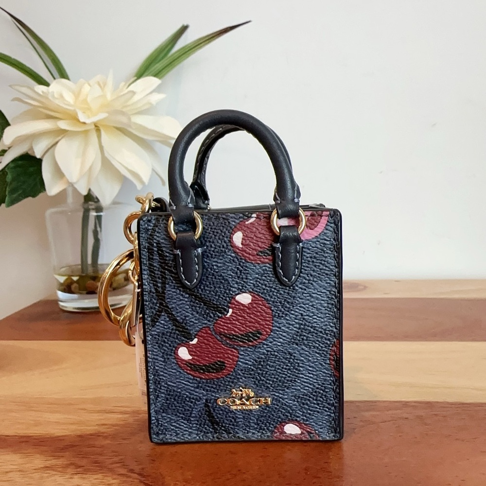 NWT Coach North /South Mini Tote Bag Charm In Signature Canvas With Cherry Print